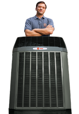 Master Mechanical technician standing over a Trane outdoor unit