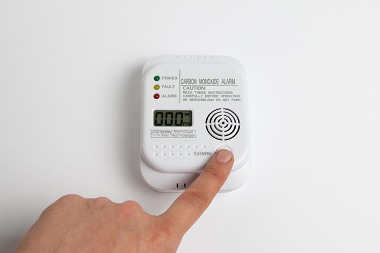Hand testing a carbon monoxide alarm