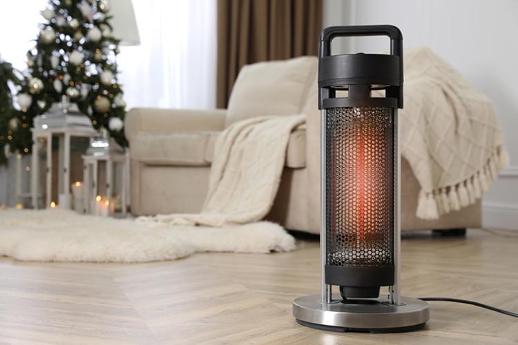 Space heater in living room with couch and christmas tree in the background.
