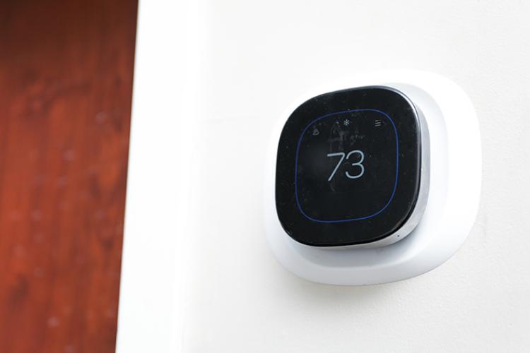 Smart thermostat on a home wall